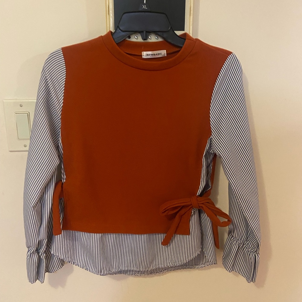 Orange vest with side bow ties with linen pants, striped blue shirt under it